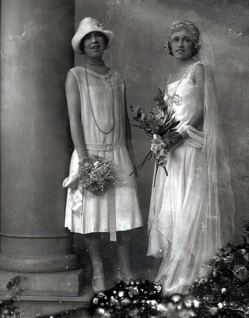 a vintage picture shows two women in their wedding attire