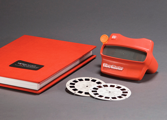 a red tape measure next to an orange notebook