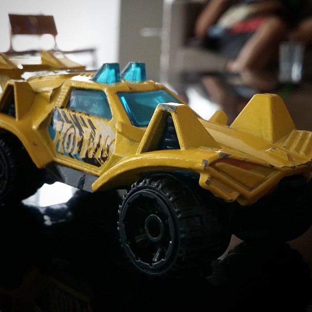 a yellow toy truck sitting on top of a table