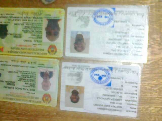 four id badges and an identification card on a table