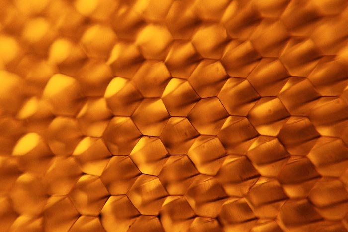 a closeup image of a gold surface, resembling an abstract design