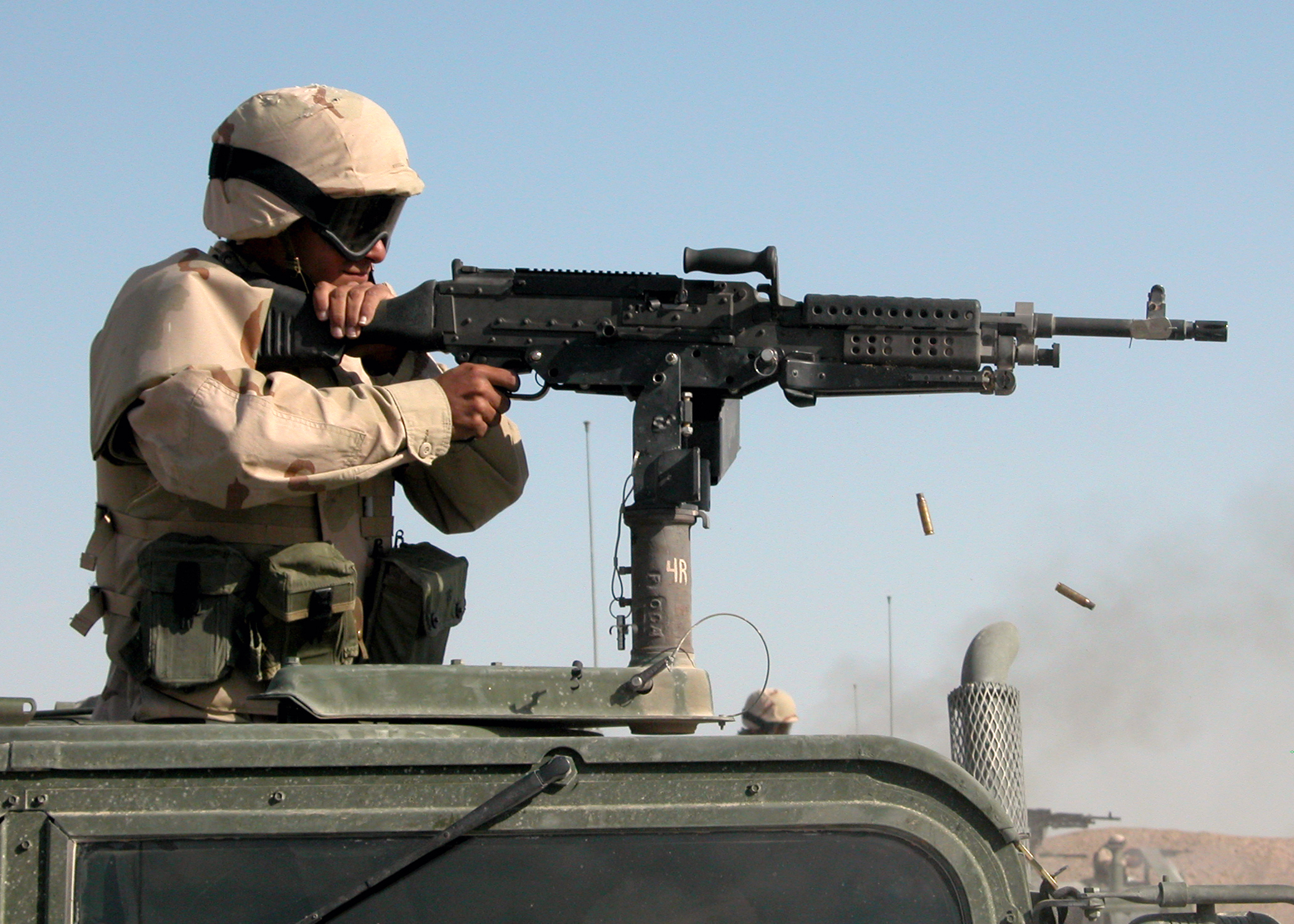 a man in a camouflage shirt holding a rifle