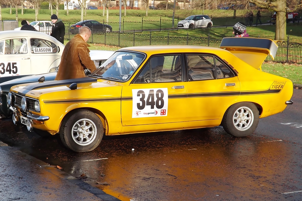 a yellow car with an engine turned on while the number 340 is being inspected