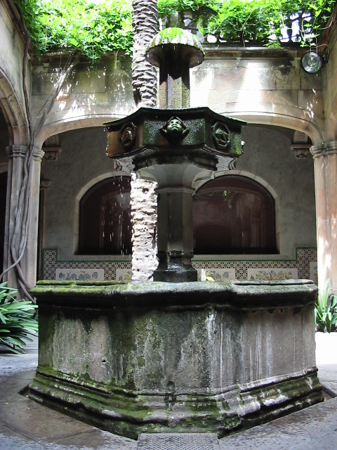 an outdoor fountain on the side of the street