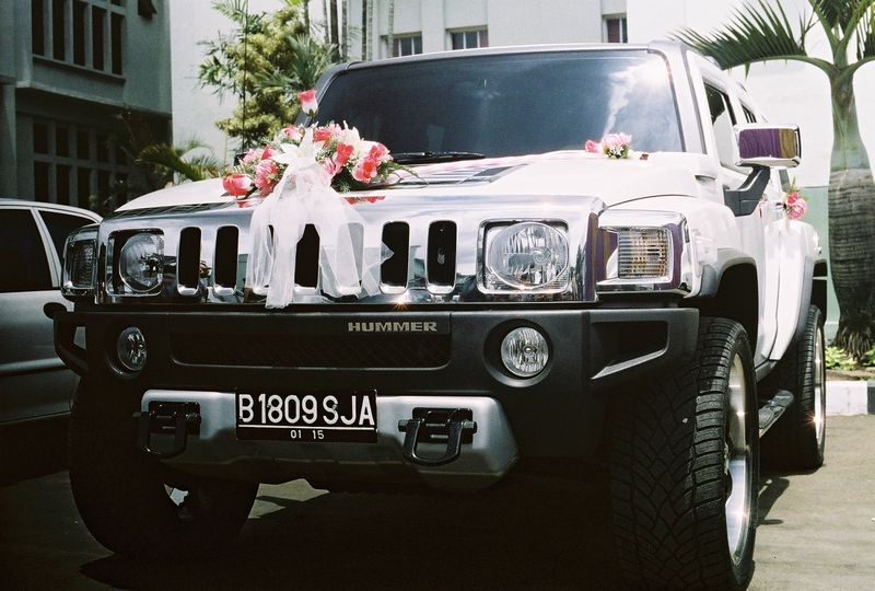a hummer that is decorated with flowers and ribbons