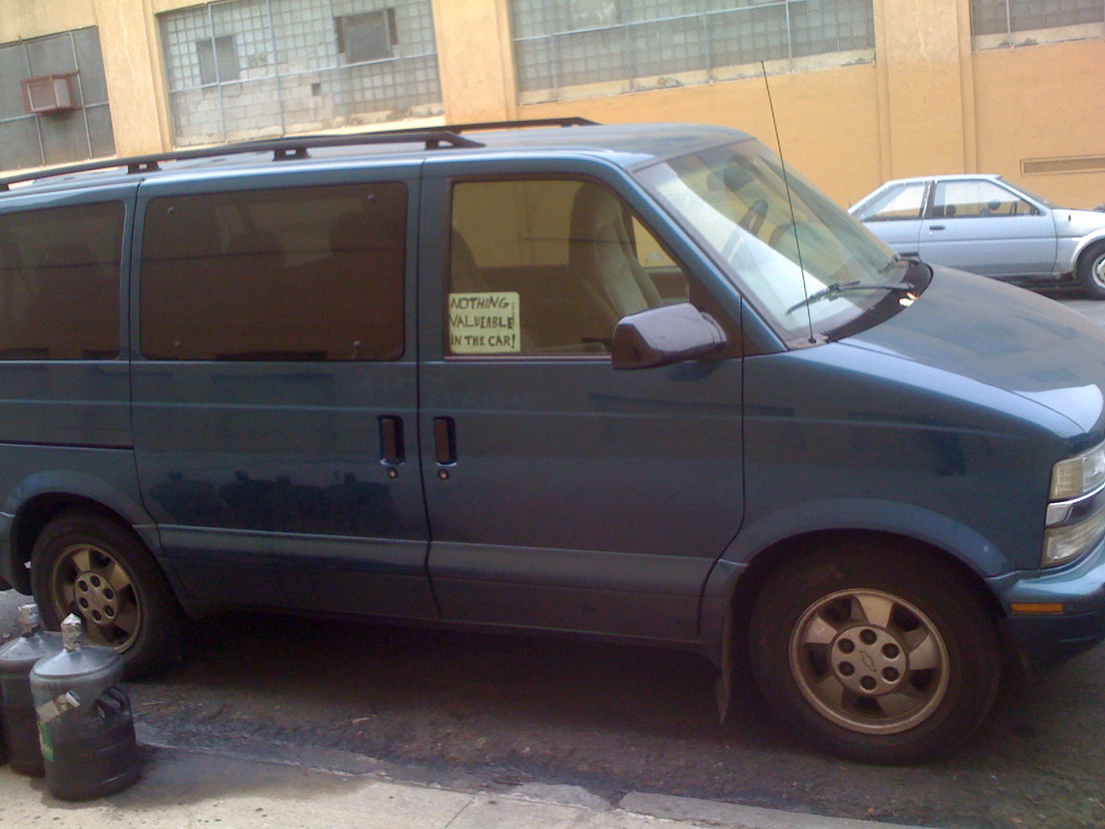 a car parked by the side of the road with a sign that says no parking