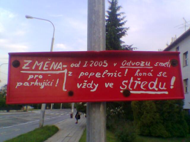 a sign that has been vandalized and is on a street pole