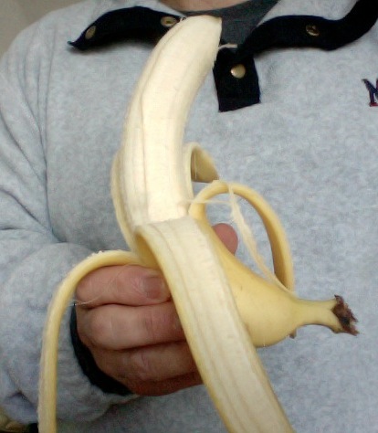 a man is holding a banana in his hand