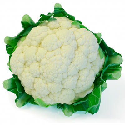 a cauliflower head laying on its leafy top