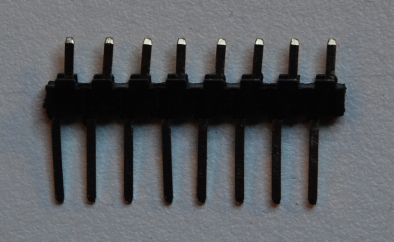 a group of black electrical terminales on a surface