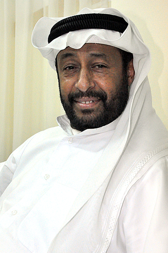 a man in a white outfit smiles for the camera