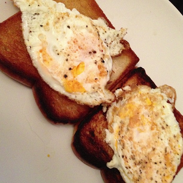 eggs and toast with an egg on top on a plate