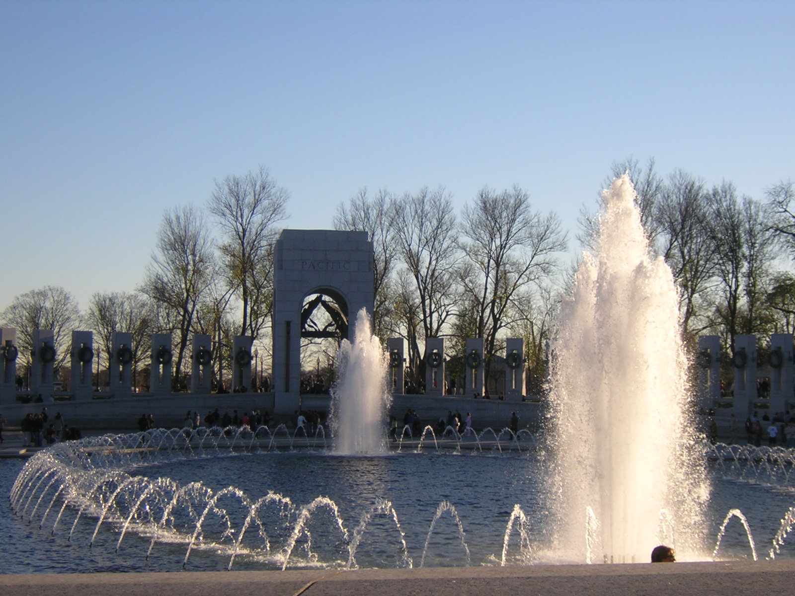 a fountain is spewing water on a clear day