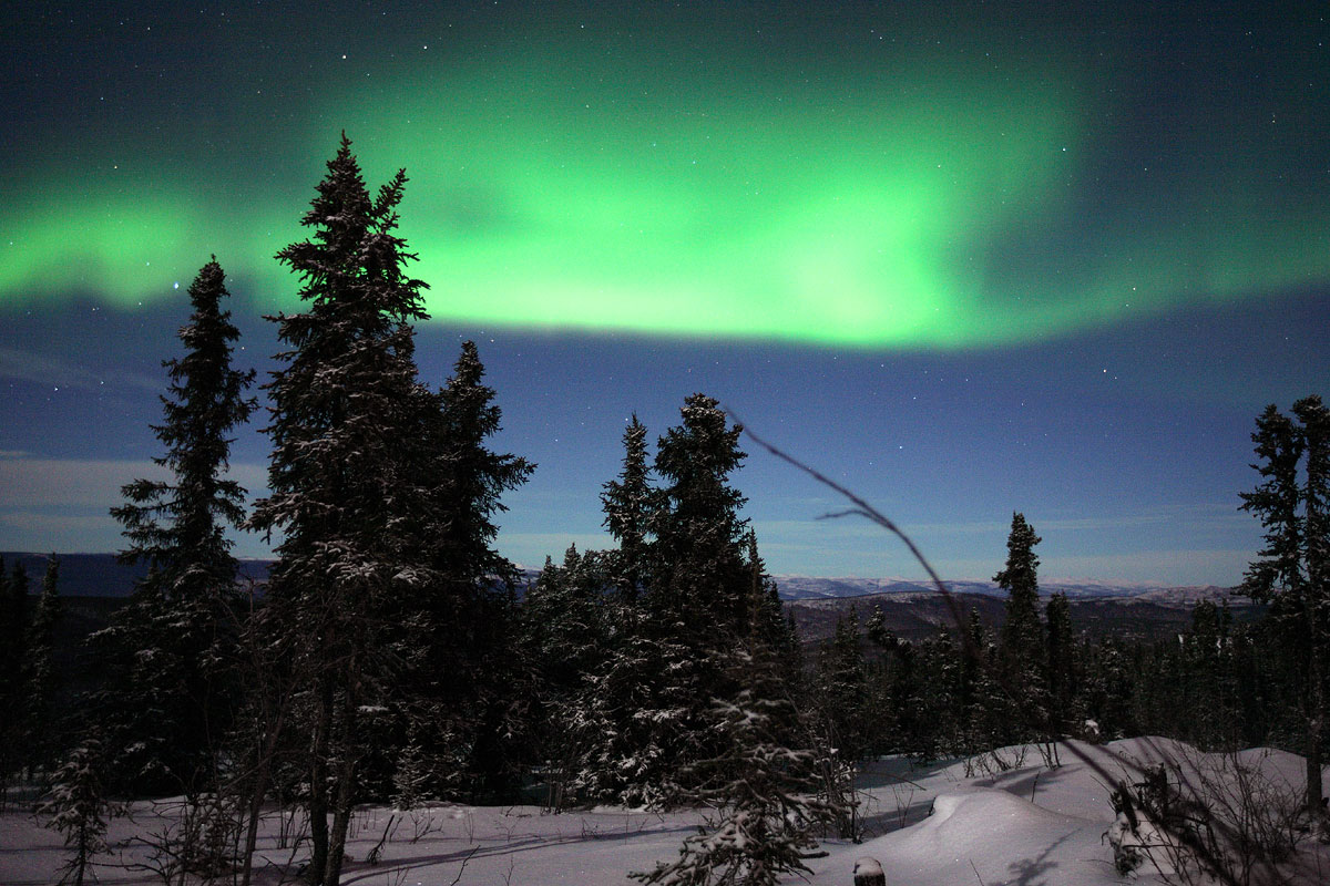 a view of the aurora from a distance with a sky line in the background