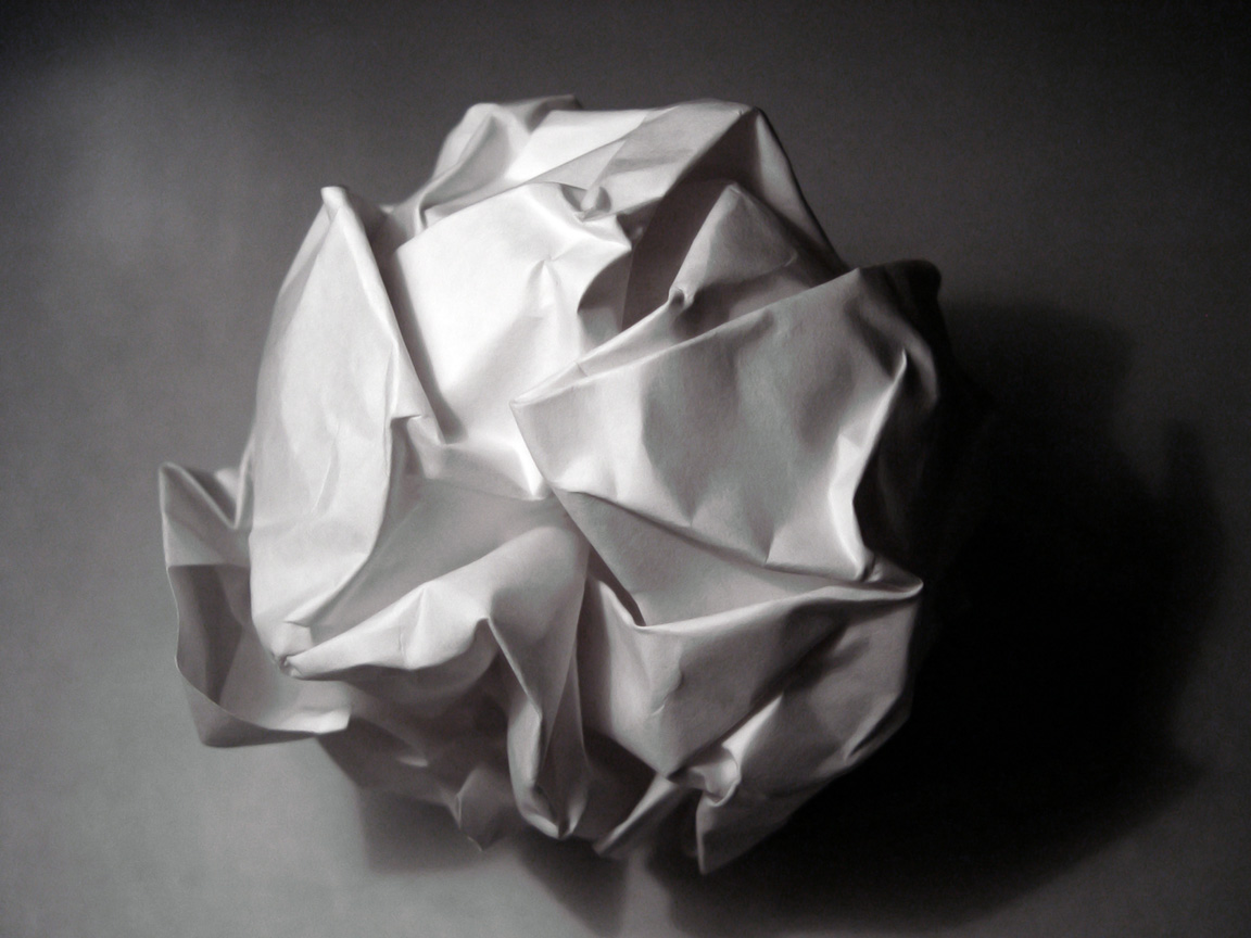 a crumpled piece of paper sitting on top of a table