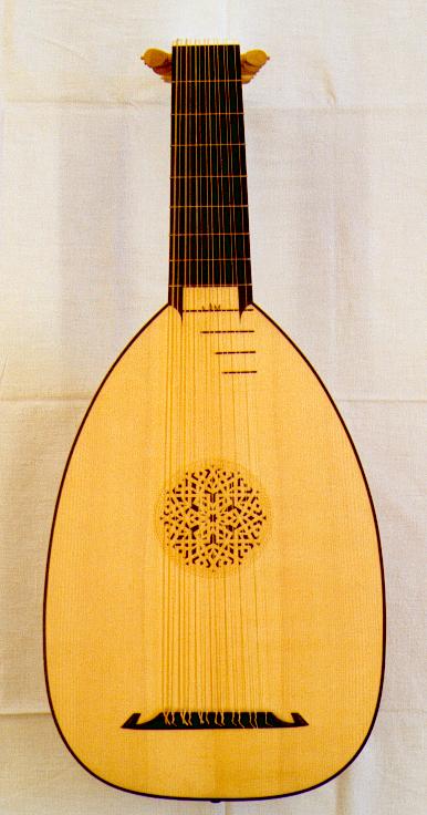 a small musical instrument that has an intricate top and a triangle design on the bottom