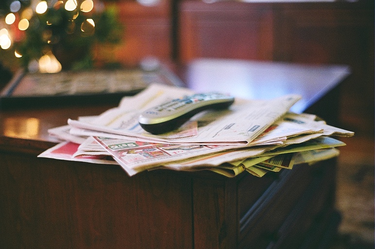 the stack of magazines is stacked on a coffee table