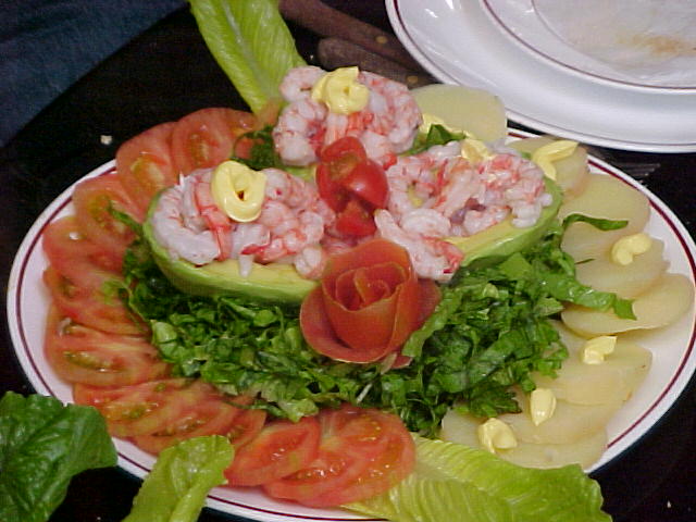 a plate filled with crab, tomato and lettuce slices