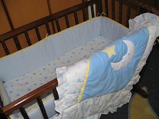 a baby crib sitting in the corner of a room
