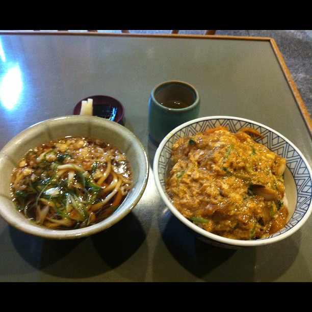 two bowls of food on a table with coffee