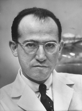 an old black and white po of a man wearing glasses