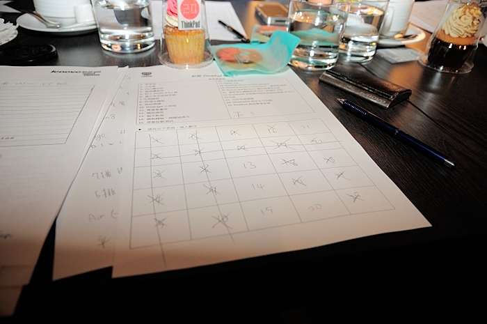 a group of glasses, drinks, and papers laid out on a table