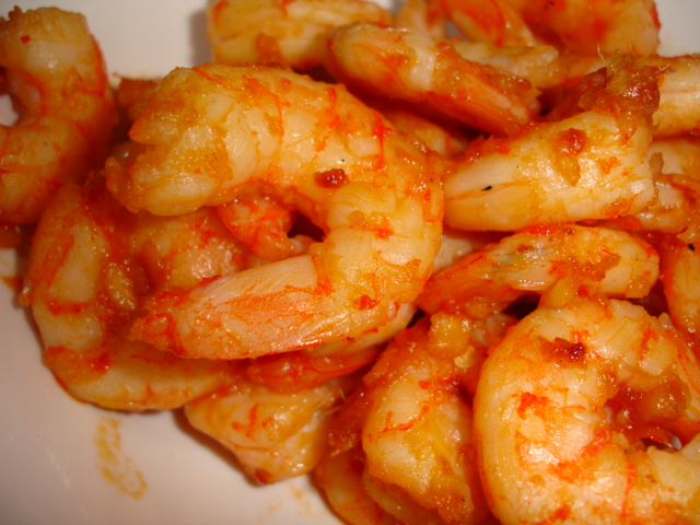 shrimp is piled high on the plate and sauce