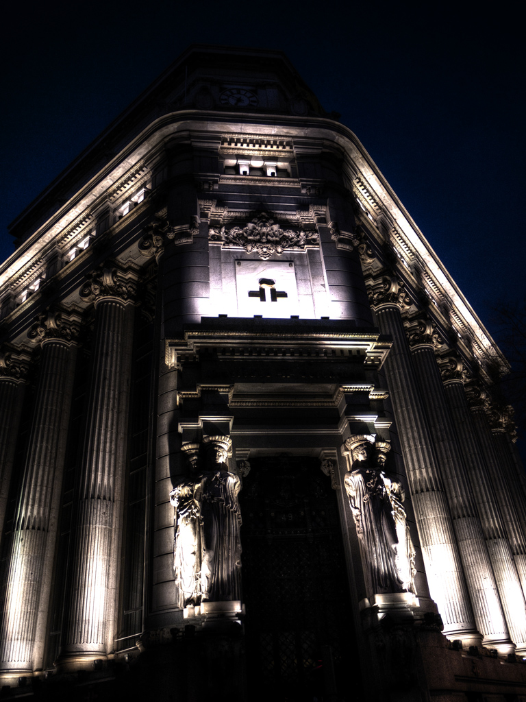 an ornate building with lit up crosses at night