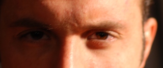 a man looking into the distance with only his left eye missing