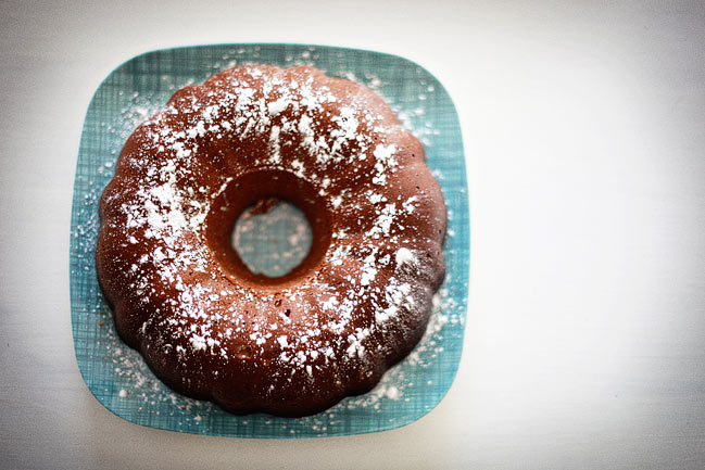 a powdered doughnut sits on a blue plate