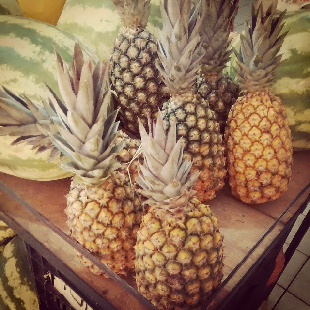 a pile of pineapples on display for sale