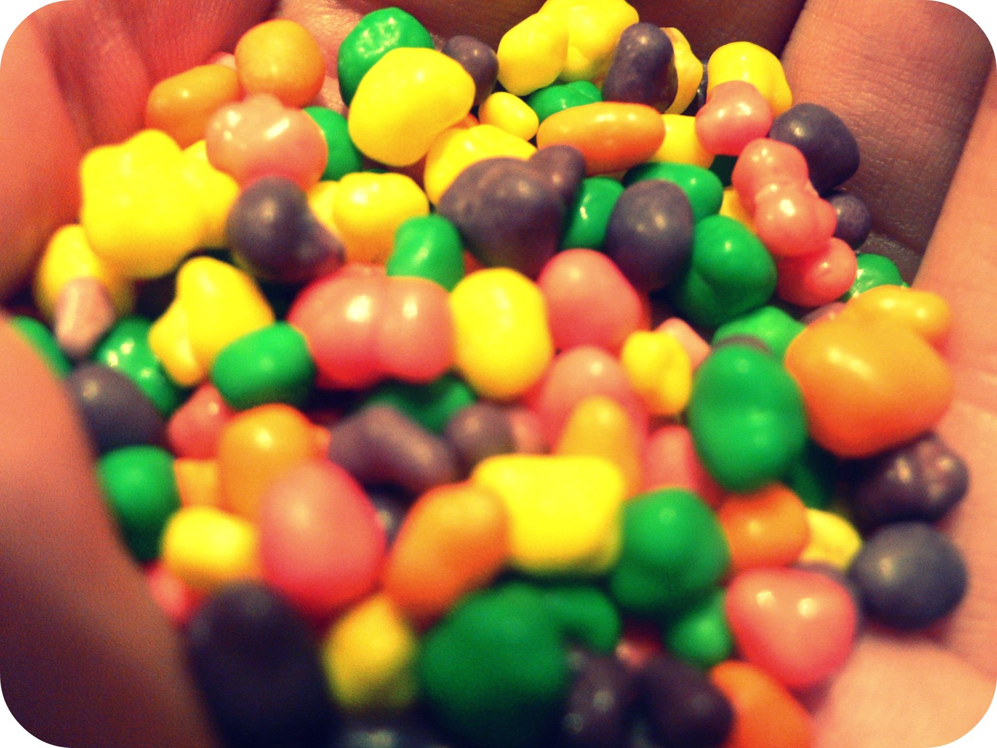 a close up of candy in a mans hands