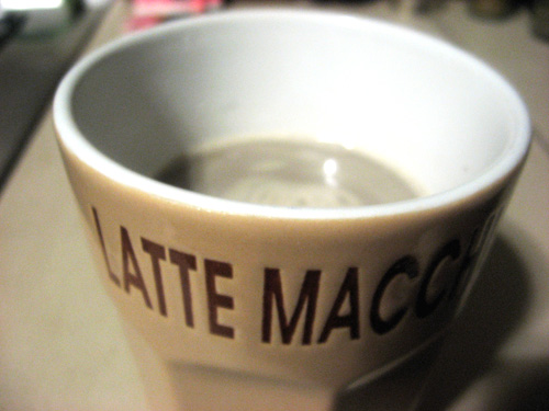 a cup of coffee sitting on top of a table