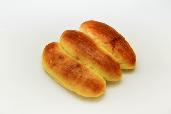 two loaves of bread laying on a white surface