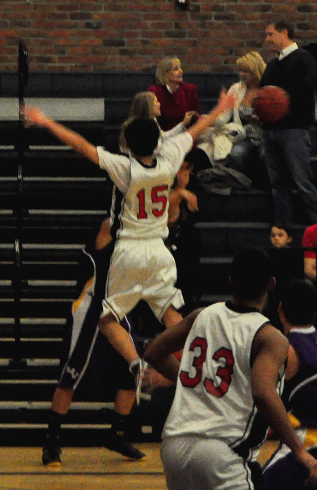 two basketball players in the air after going to dunk