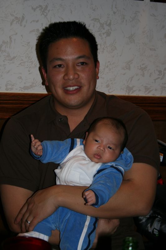 a man holding a baby who is being held up