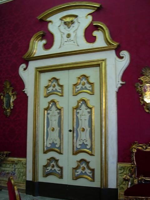 a large golden door with a decorative design