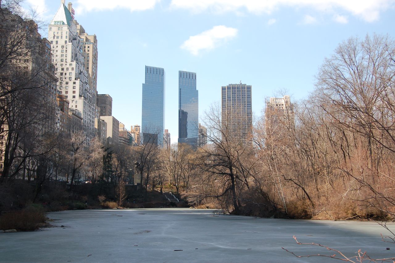 two skyscrs stand high above the skyline and a frozen river