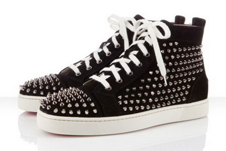 the black and white sneakers are adorned with silver studded straps