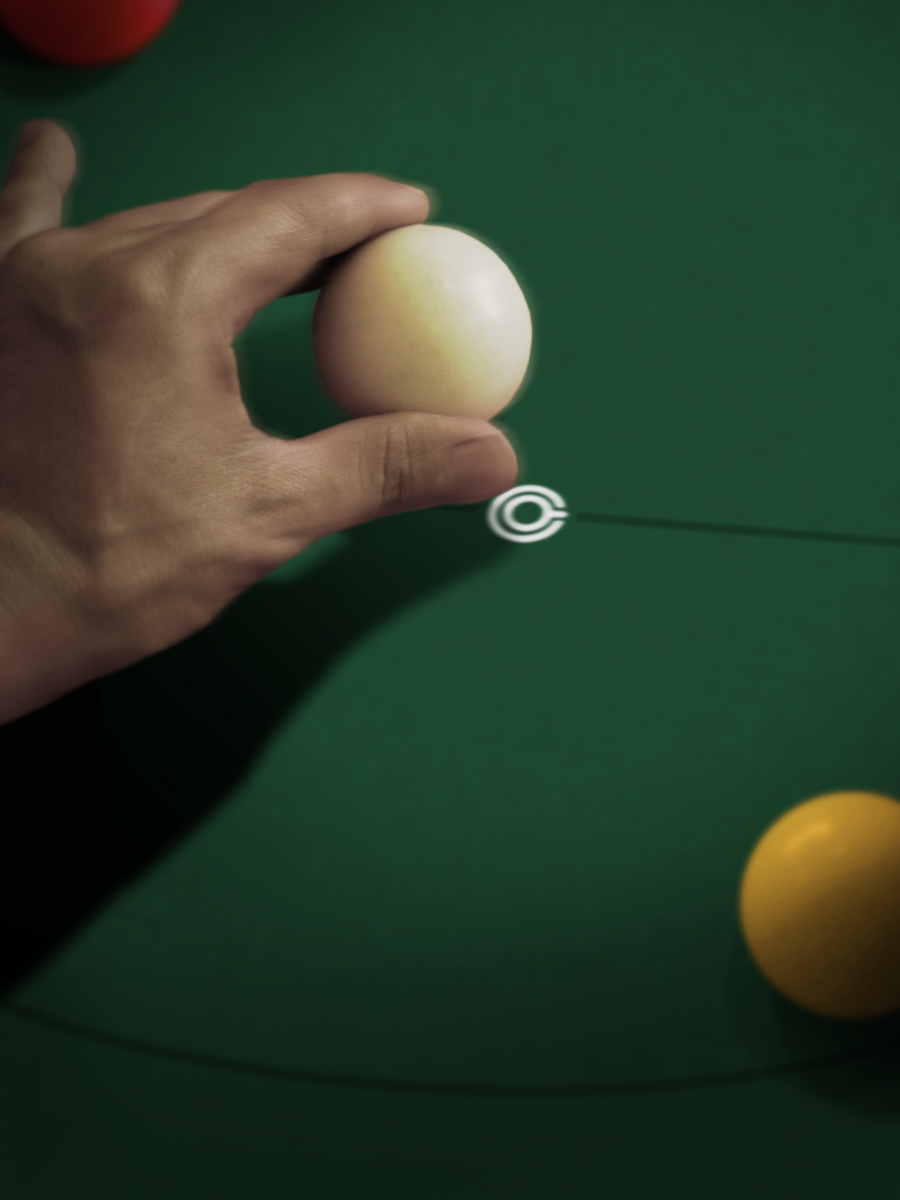 a person is holding a billiards ball in their hand