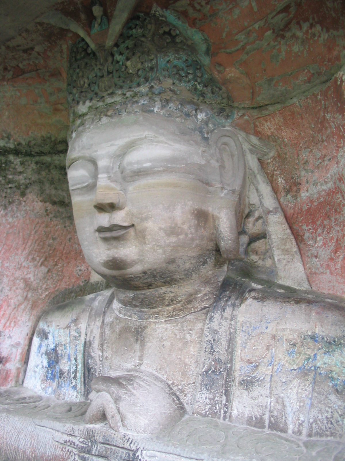 a large statue is shown sitting by a wall