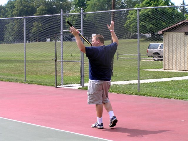 a tennis player raising his racket with both hands