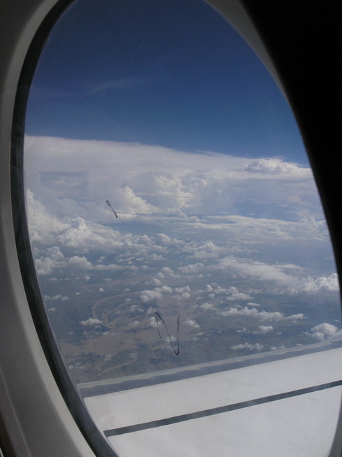 the sky and clouds from inside an airplane