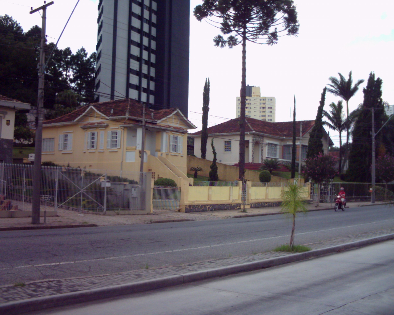 a yellow house sitting on the corner of a street