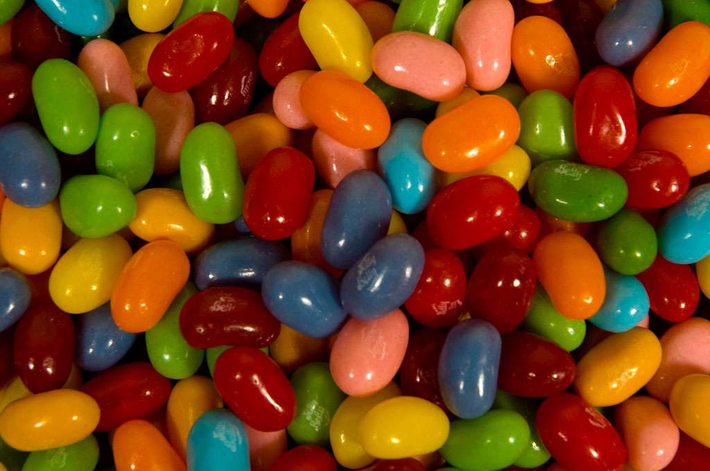 a bunch of small candy beans with one smaller