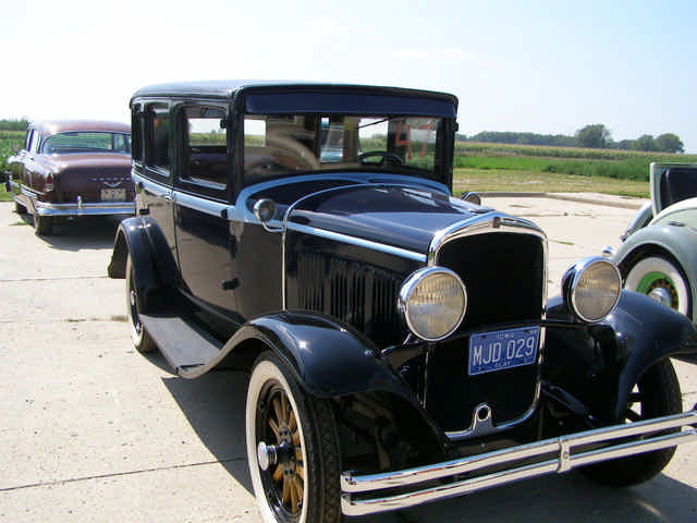 a vintage black car with the hood on