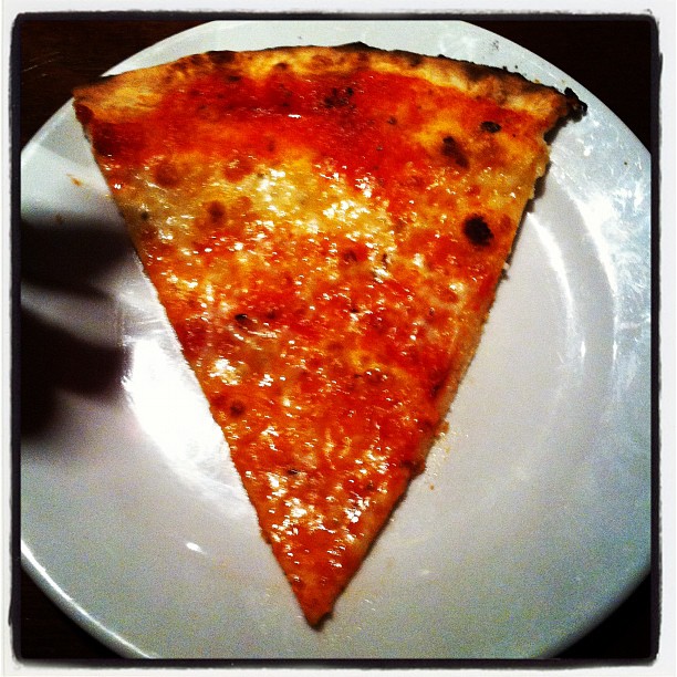 a slice of cheese pizza on a plate