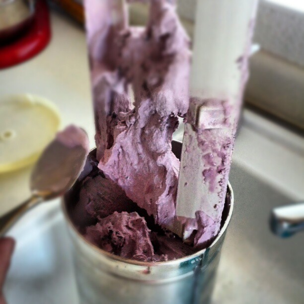 a bucket filled with ice cream covered in blue purple purple