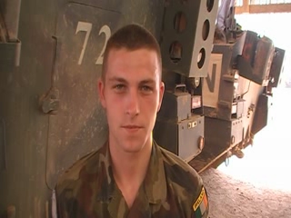 a young man in uniform is standing near a wall