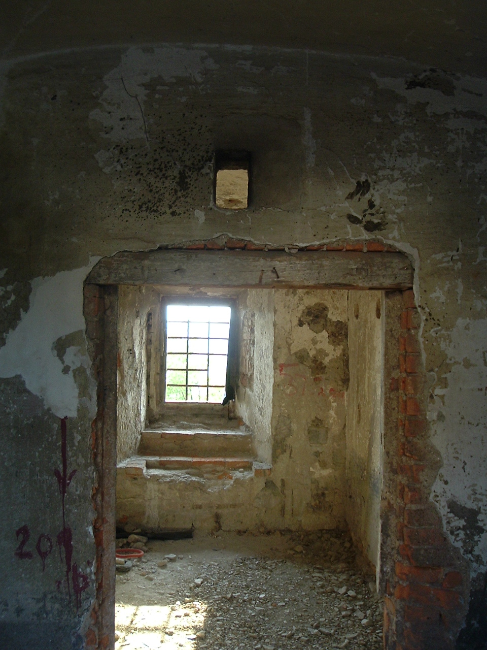 a hallway with a barred window in a building
